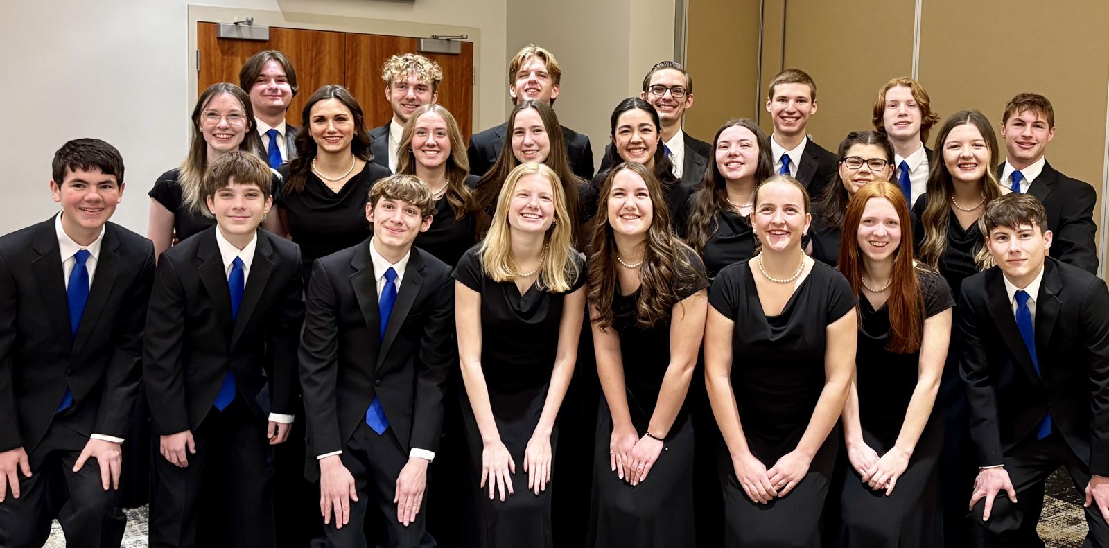 Choir students in concert dress posing together