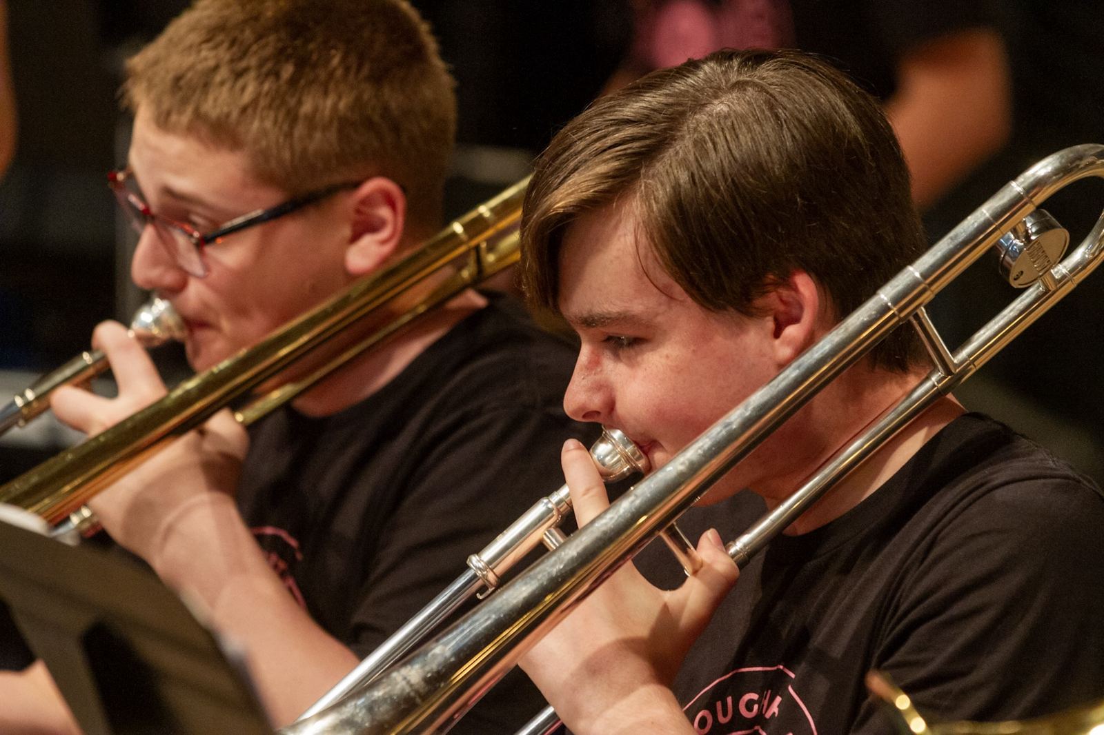 Two trombone players in band rehearsal